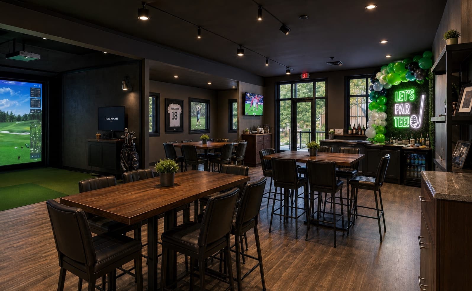 The private party room — dark wood tables, its own simulator, and a let's par-tee neon with a balloon arch